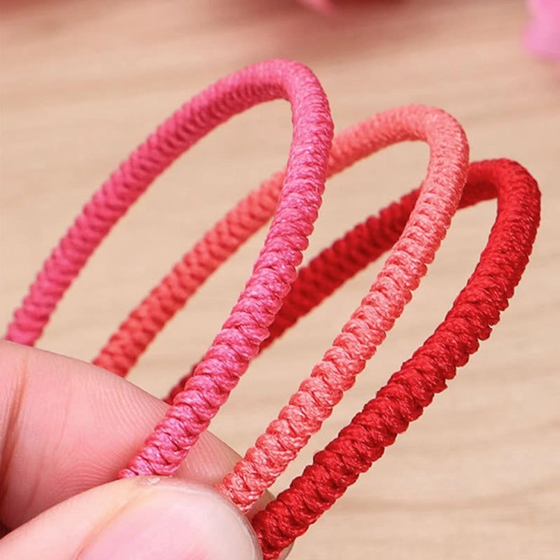 Multiple Tibetan braided bracelets stacked layered red string protective energy