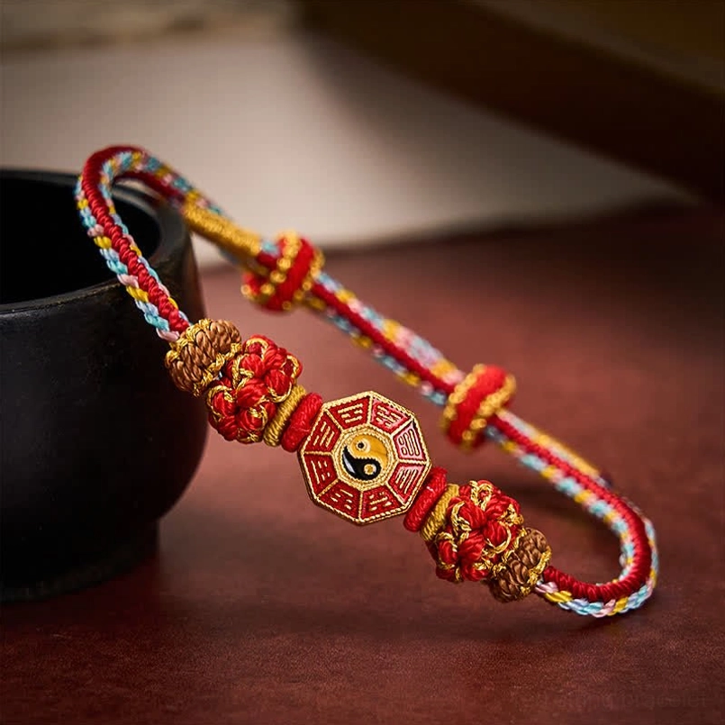 Adjustable Tibetan red string bracelet side view showing sliding buckle and weave detail