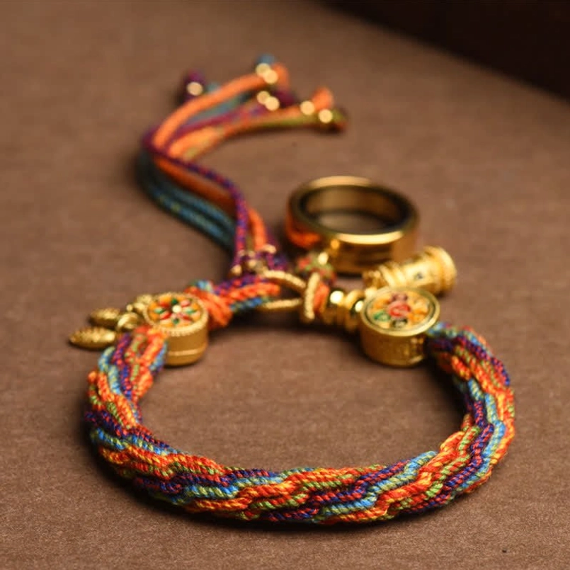 Tibetan lucky red string bracelet flat lay view on dark brown background