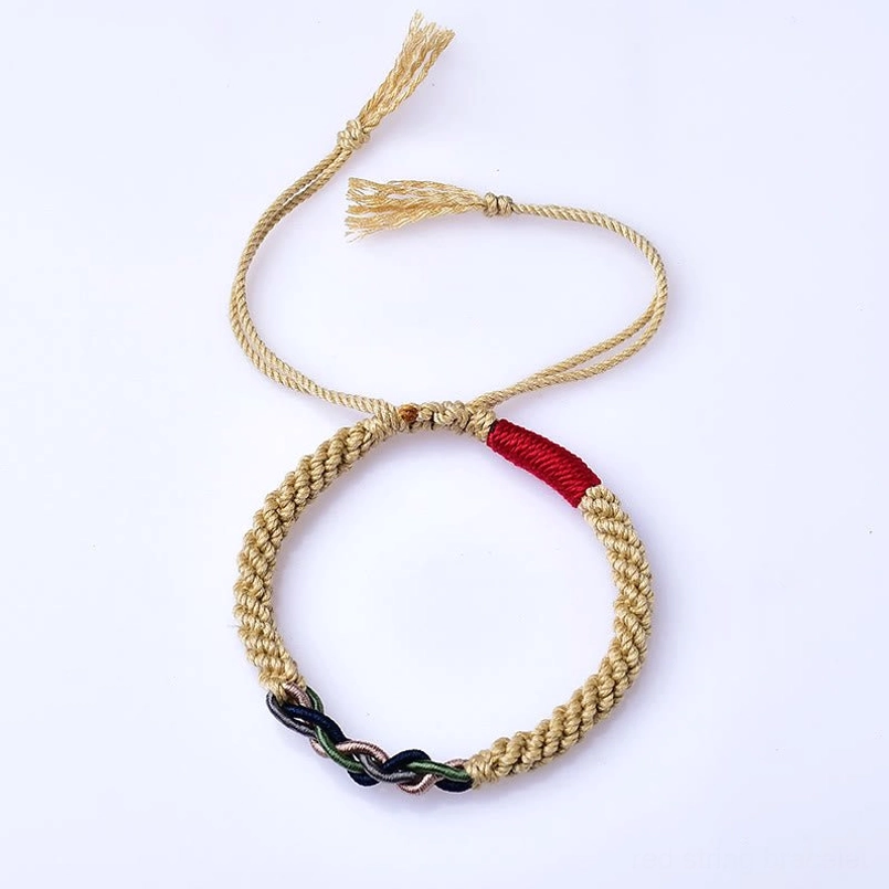 Flat front overhead view of adjustable Tibetan red string luck bracelet on white background, showing complete design with tassel cords