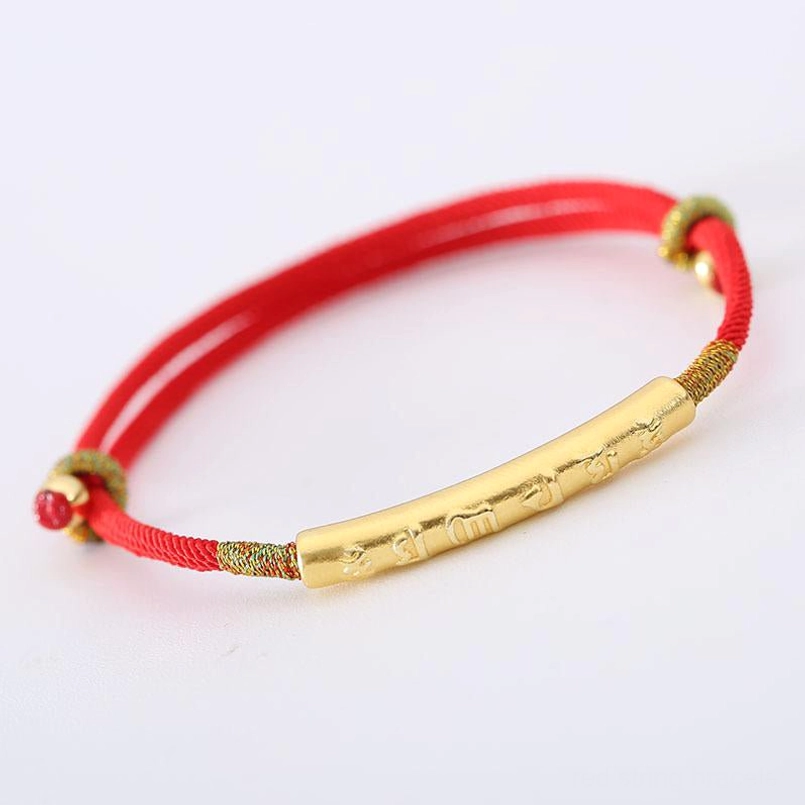 Tibetan Om Mani Padme Hum red braided cord bracelet with gold mantra tube and metal toggle ends on white background