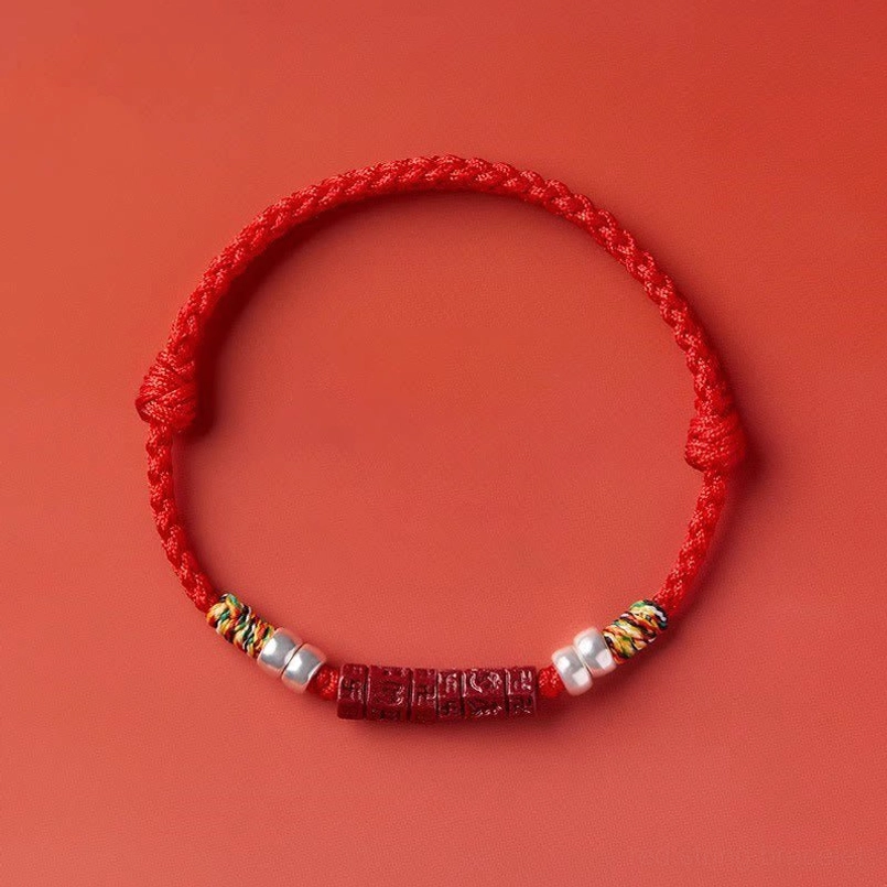 Tibetan red string bracelet with engraved mantra bead and braided cord construction