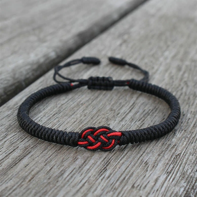 Red string protection bracelet with natural rope material showing eco-friendly sustainable craft
