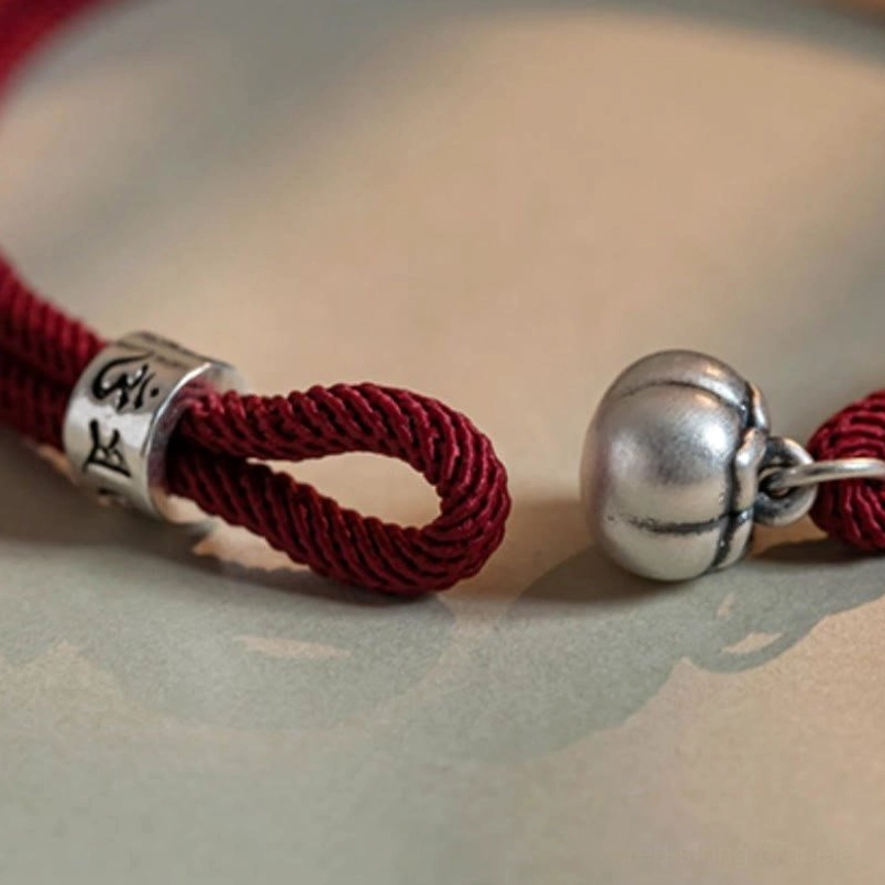 Tibetan red string protection bracelet with silver om mani padme hum engraved charm