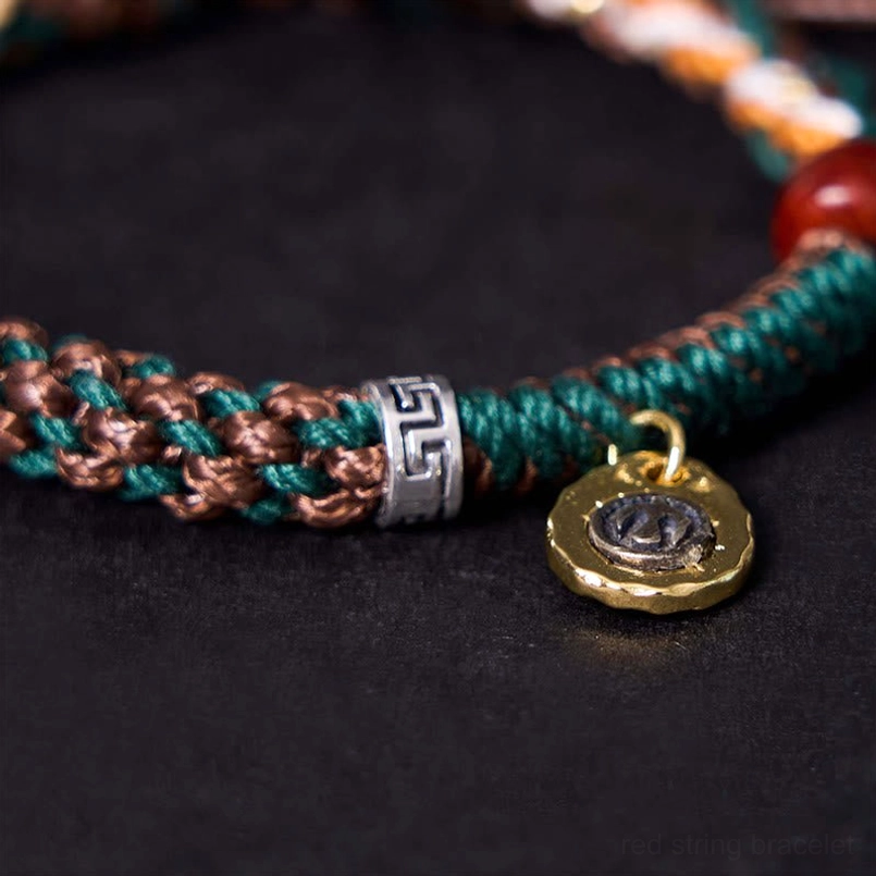 Macro close up of Tibetan braided bracelet texture with engraved metal ring