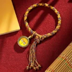 Tibetan five gods of wealth dragon scale yellow rope bracelet with face pendant and tassel on red velvet