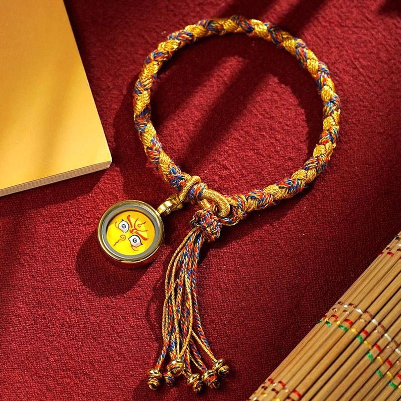 Tibetan five gods of wealth dragon scale yellow rope bracelet with face pendant and tassel on red velvet