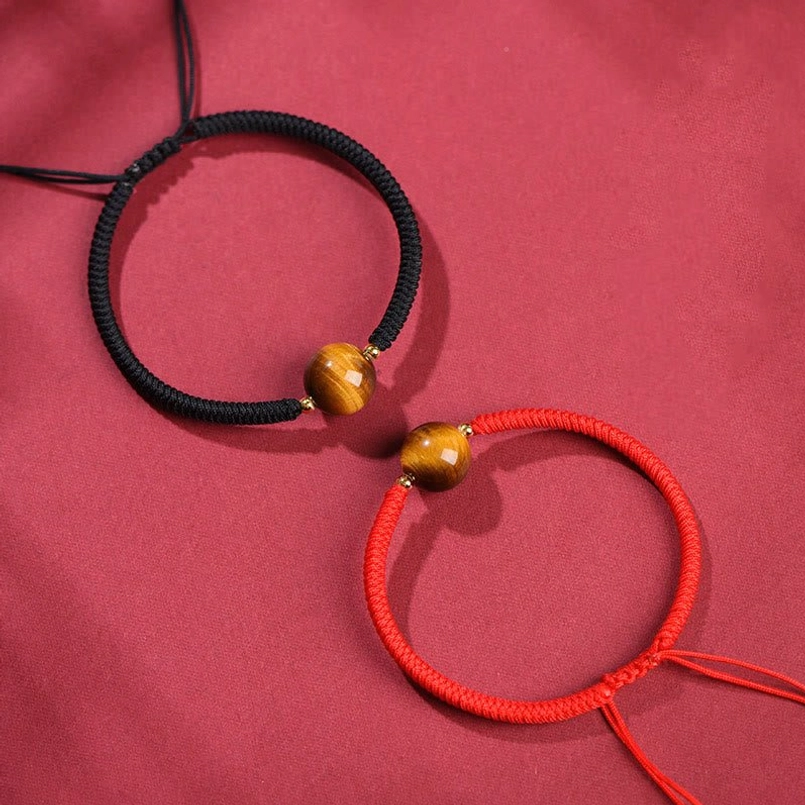 Handmade tiger eye bracelet collection showing red and black rope color options