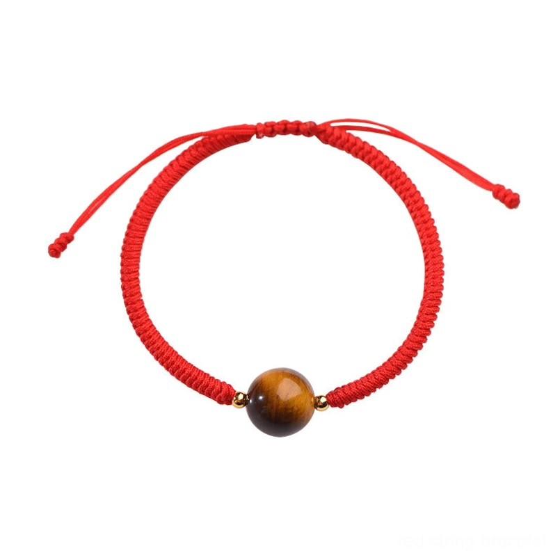 Minimalist tiger eye red string bracelet single bead on white background