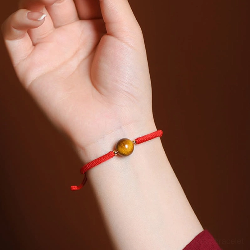 Tiger eye bracelet on wrist side angle showing slim fit braided cord design