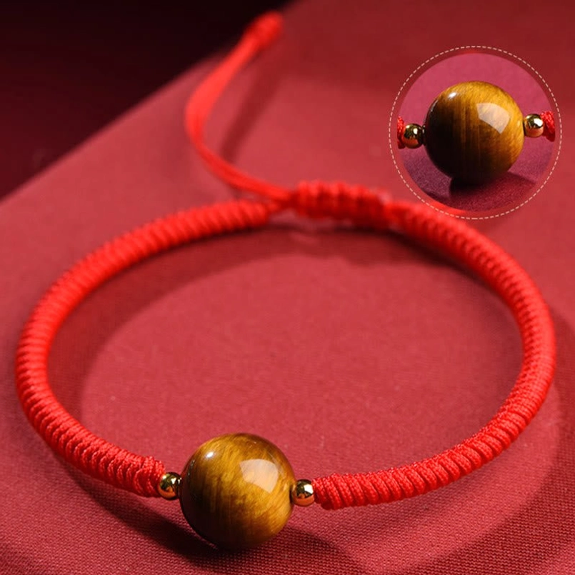Tiger eye bead close-up zoom showing natural stone texture and golden striations detail