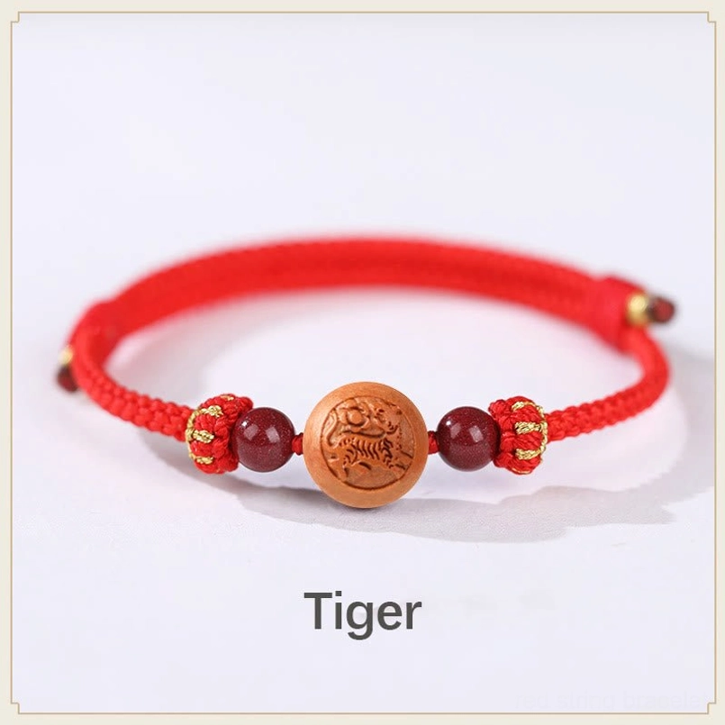 Tiger zodiac peach wood embossed bracelet with red braided rope - courage and power talisman