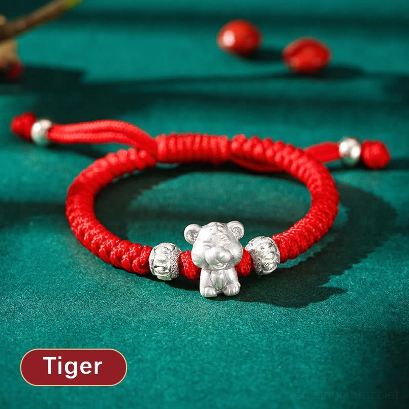 Tiger Chinese zodiac 999 sterling silver woven red rope bracelet flat lay with decorative beads