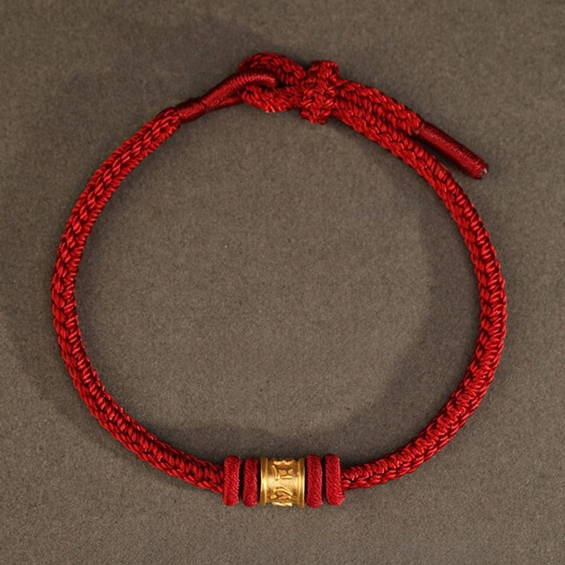 Top down full view of Tibetan 999 gold red string luck bracelet