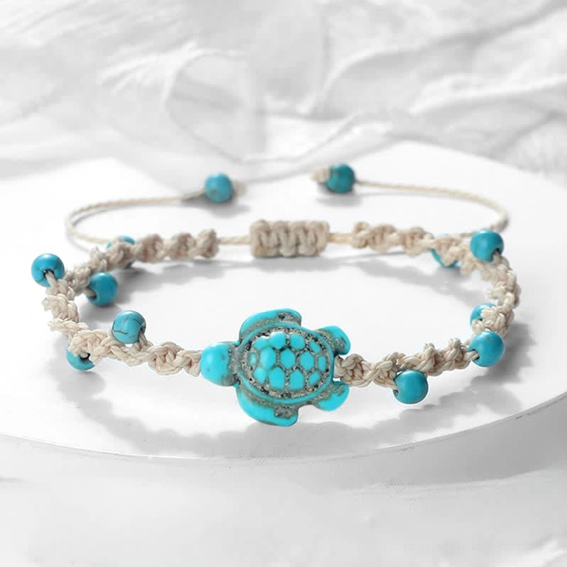 Turquoise turtle woven rope bracelet flat lay with adjustable sliding knot closure