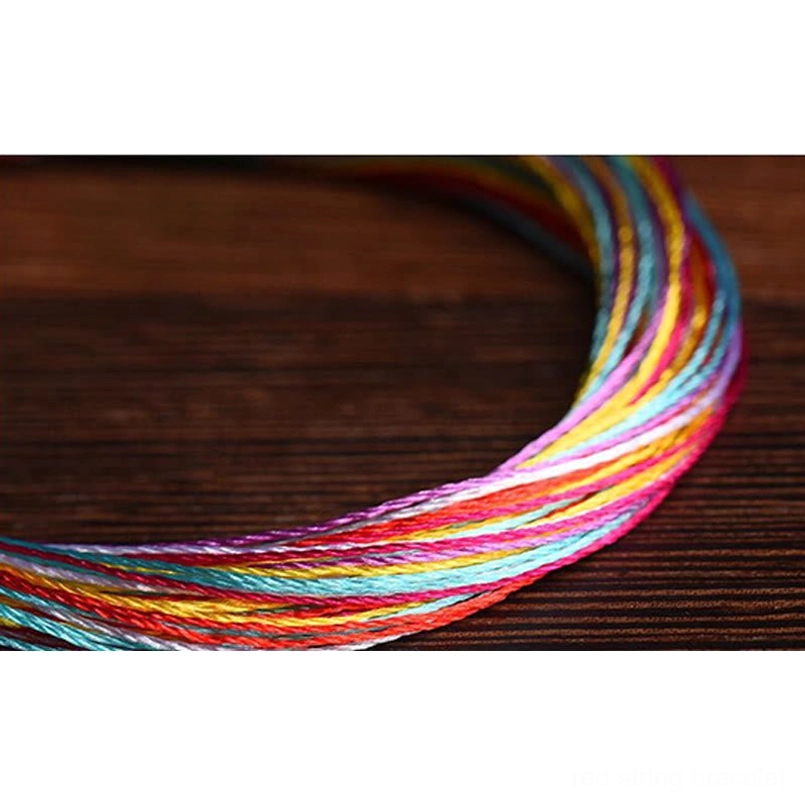 Tightly twisted rainbow five color red string threads close up view