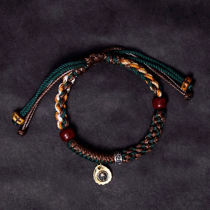 Two layer Tibetan braided luck bracelet with red beads and skull pendant