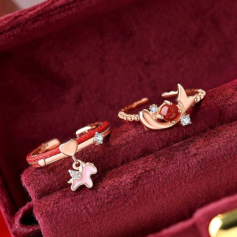Unicorn and antler adjustable rings with red agate micro crystals and red woven band close-up