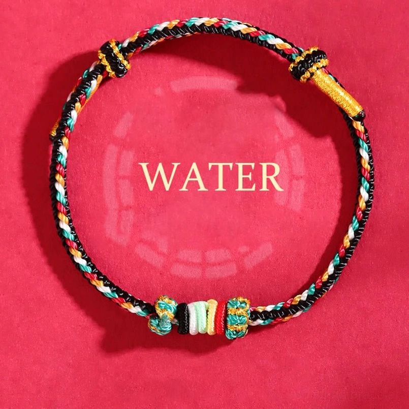 Water element black and colorful braided wuxing bracelet with spacer beads on red bagua feng shui background