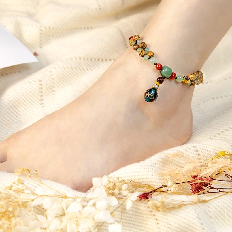 Close-up side view of wenge wood green aventurine beaded anklet worn on person's ankle