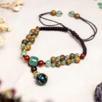 Wenge wood green aventurine beaded anklet flat lay with dried flowers and glass pendant charm