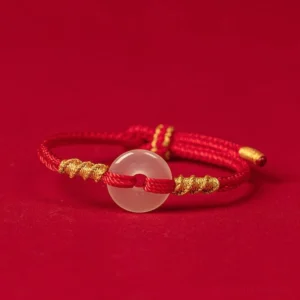 White chalcedony peace buckle red string bracelet with gold twisted knots, flat front view