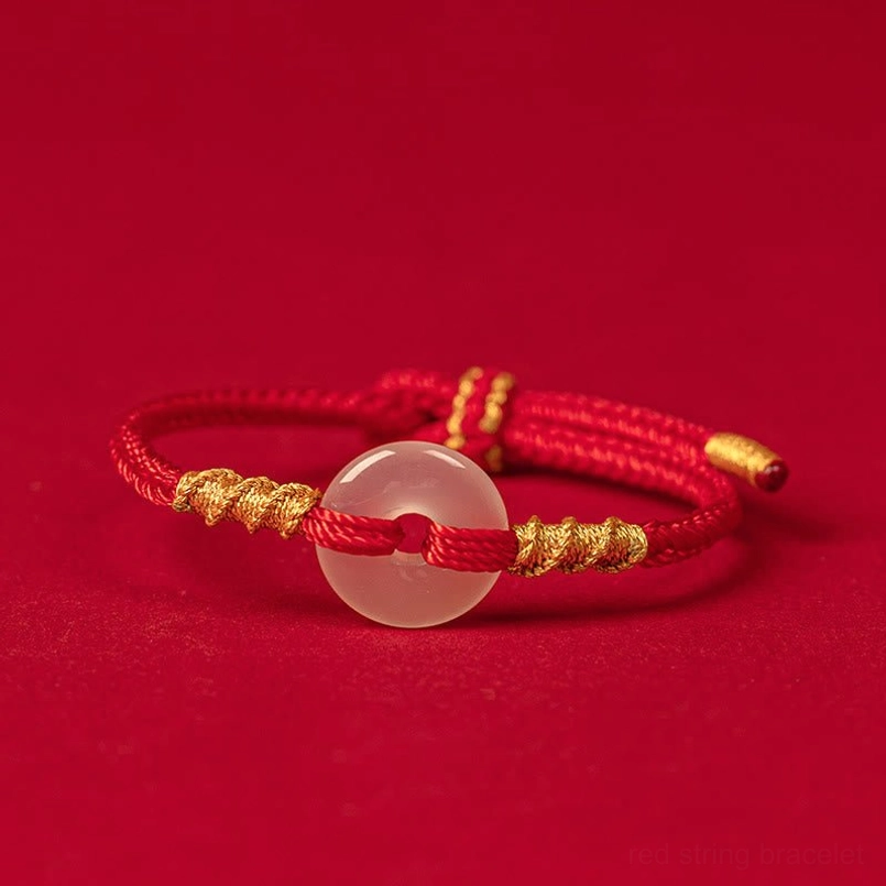 White chalcedony peace buckle red string bracelet with gold twisted knots, flat front view