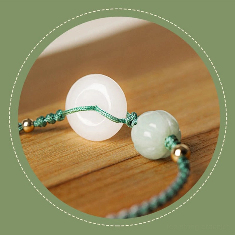 Circular framed white jade peace buckle bracelet with green pumpkin bead and gold accents