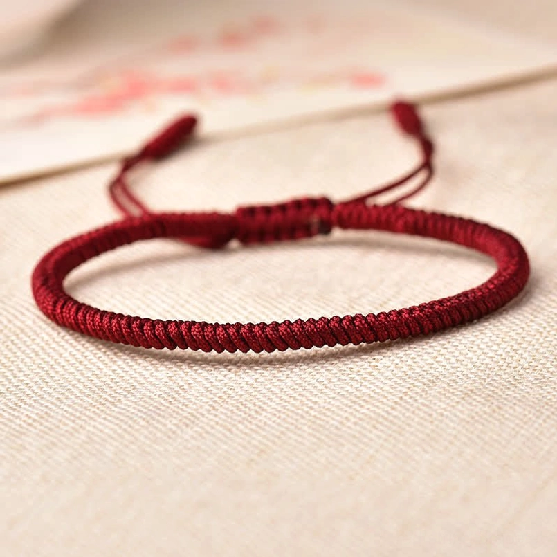Wine red woven Tibetan bracelet with pull-tie closure and tight braided texture