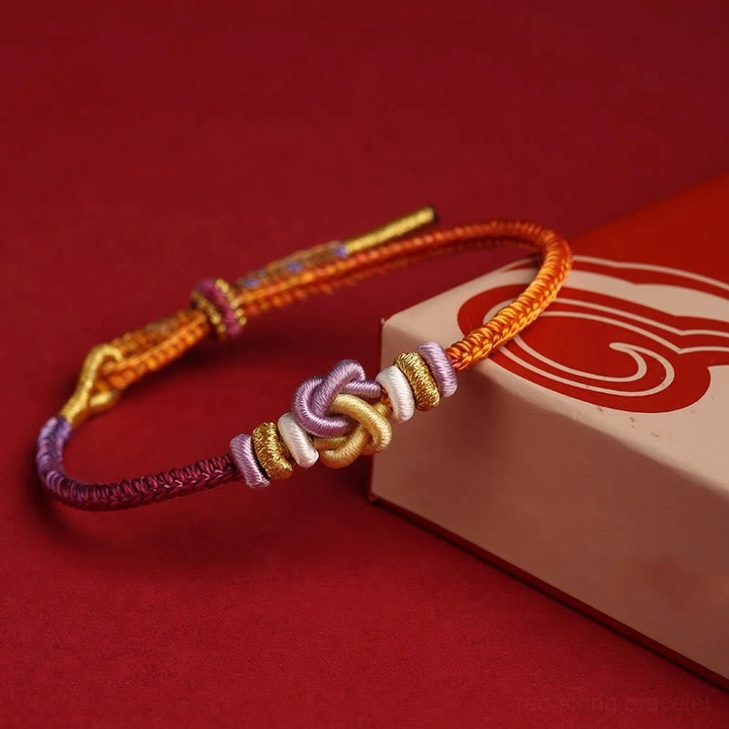 Hand-woven friendship bracelet with warm and cool tone threads braided design