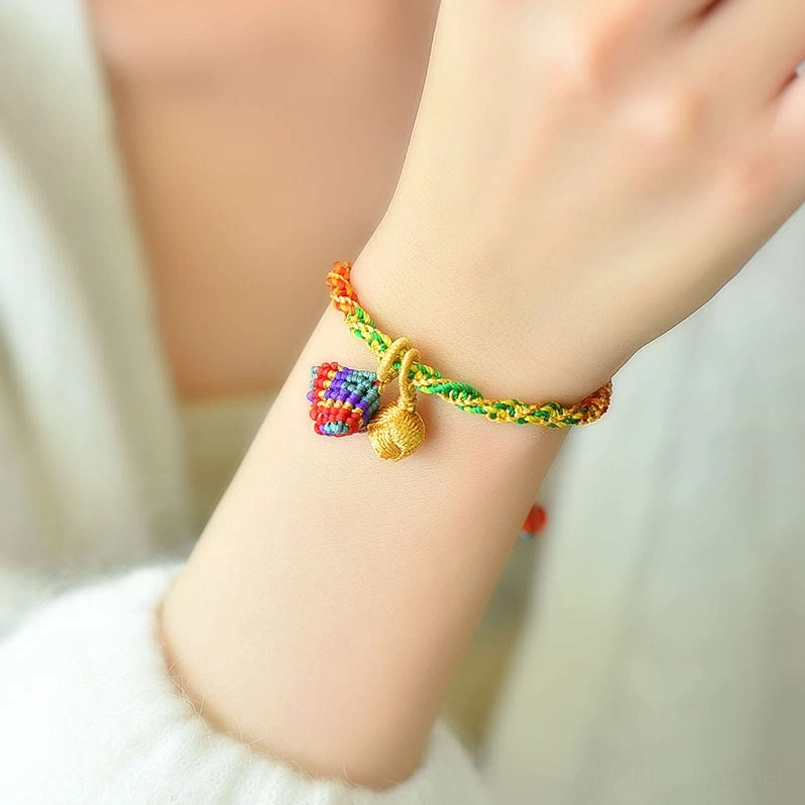 Woman wearing five element charm bracelet on wrist in daily lifestyle setting