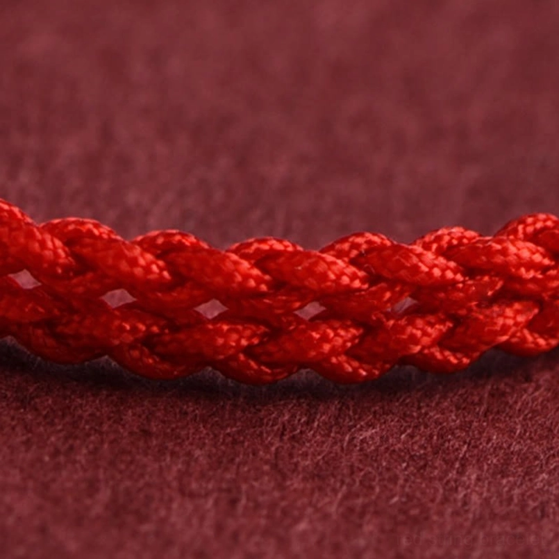 Pair of Year of the Horse red string bracelets showing matching design and sterling silver coin details