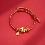 Year of the Horse red string copper braided bracelet with horse charm and gourd pendant on red background