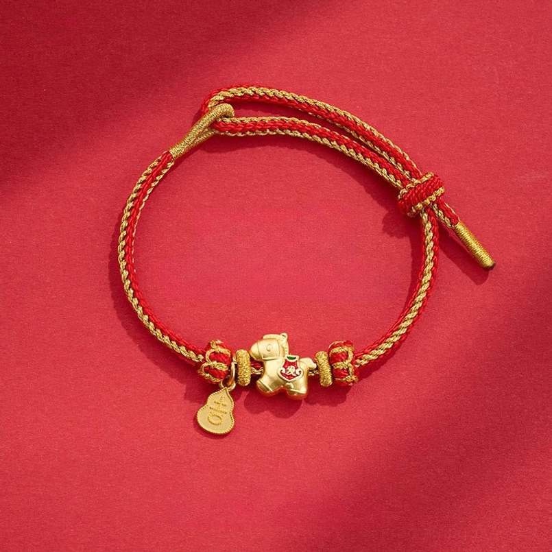 Year of the Horse red string copper braided bracelet with horse charm and gourd pendant on red background