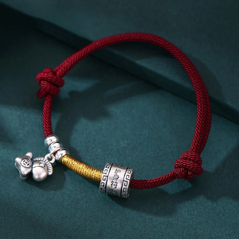 Horse zodiac red rope bracelet featuring adjustable silver beads and dual fastening knots