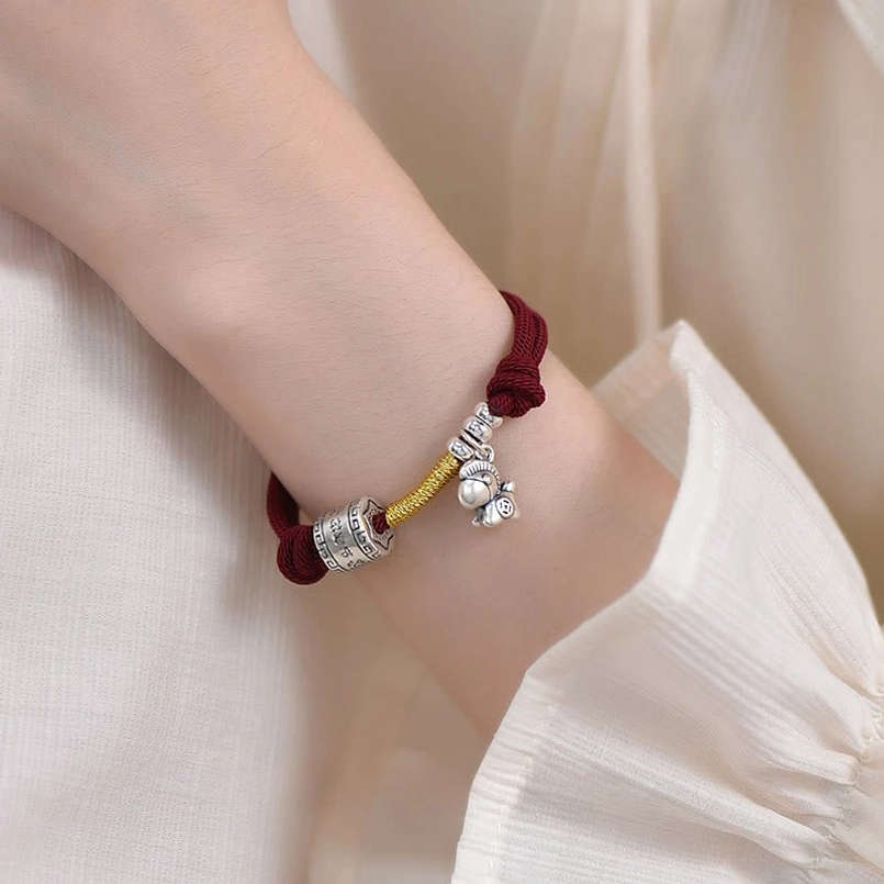 Year of the Horse red rope bracelet worn on inner wrist showing back view detail