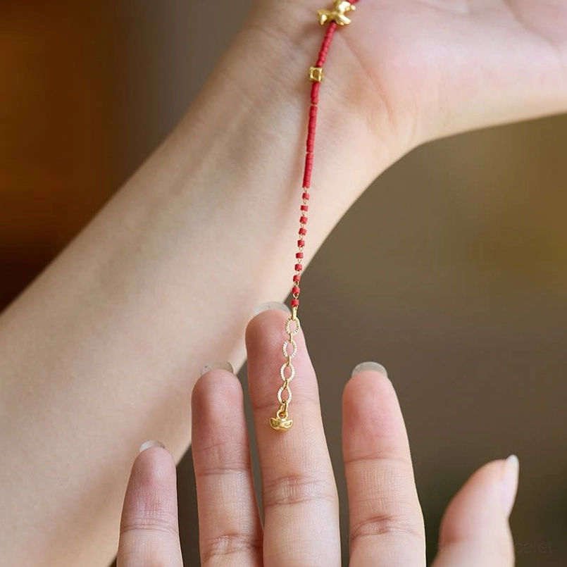 Red liuli glass horse bracelet laid along wrist showing fit and sizing measurement