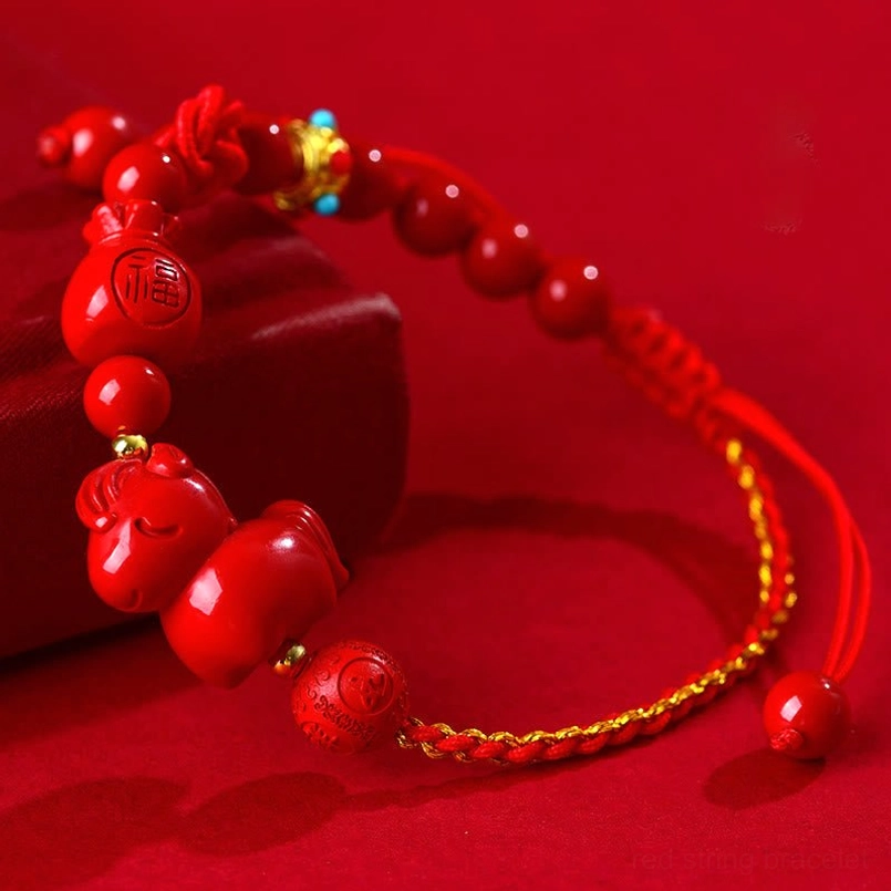 Year of the Horse Cinnabar Fu Character Lucky Red String Bracelet on red background