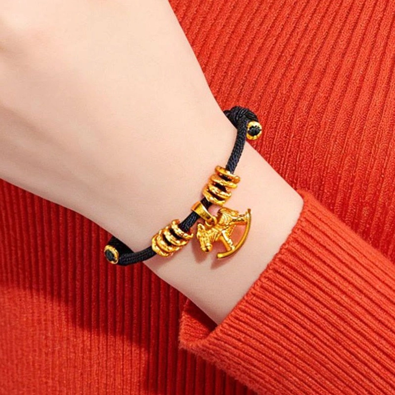 Year of the horse red string bracelet placed next to 2026 lucky fortune card