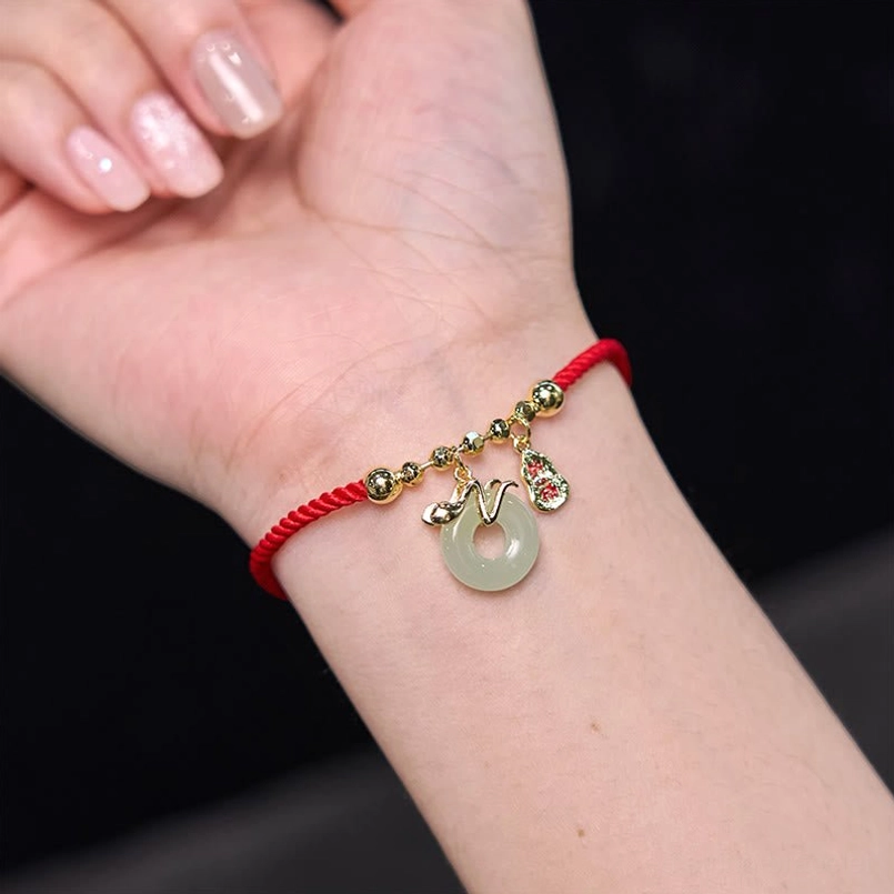 Year of the Snake 2025 red string bracelet with protective jade and fu symbol charms