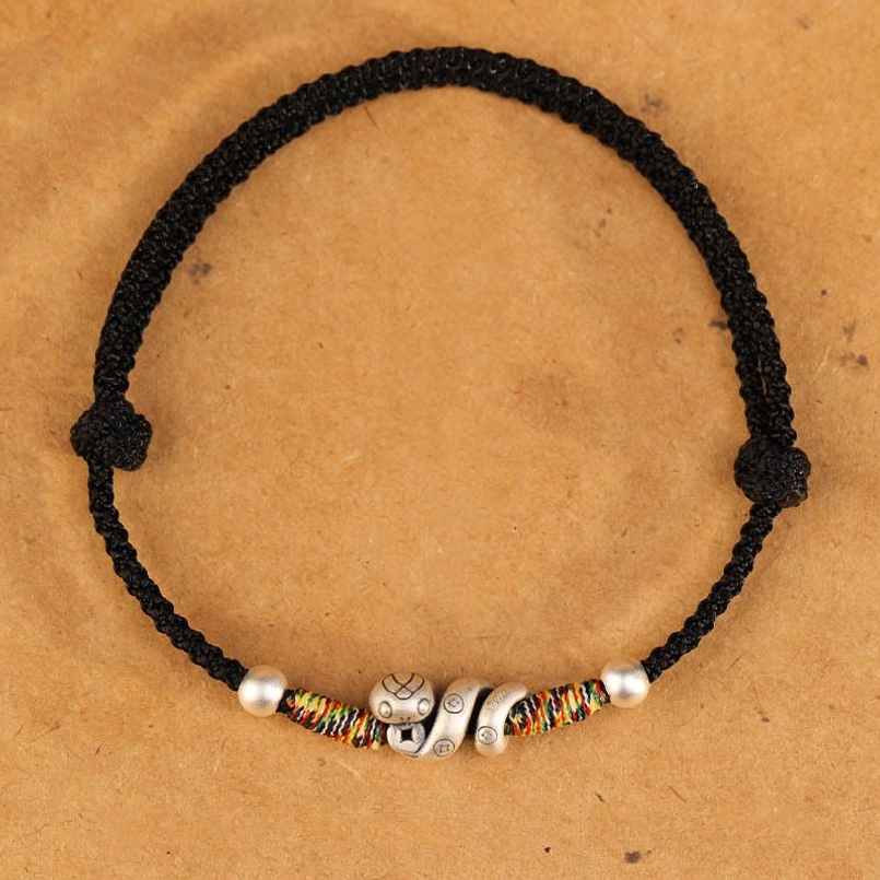 Year of the Snake red string anklet with 999 sterling silver snake charm representing wisdom, transformation, and good fortune