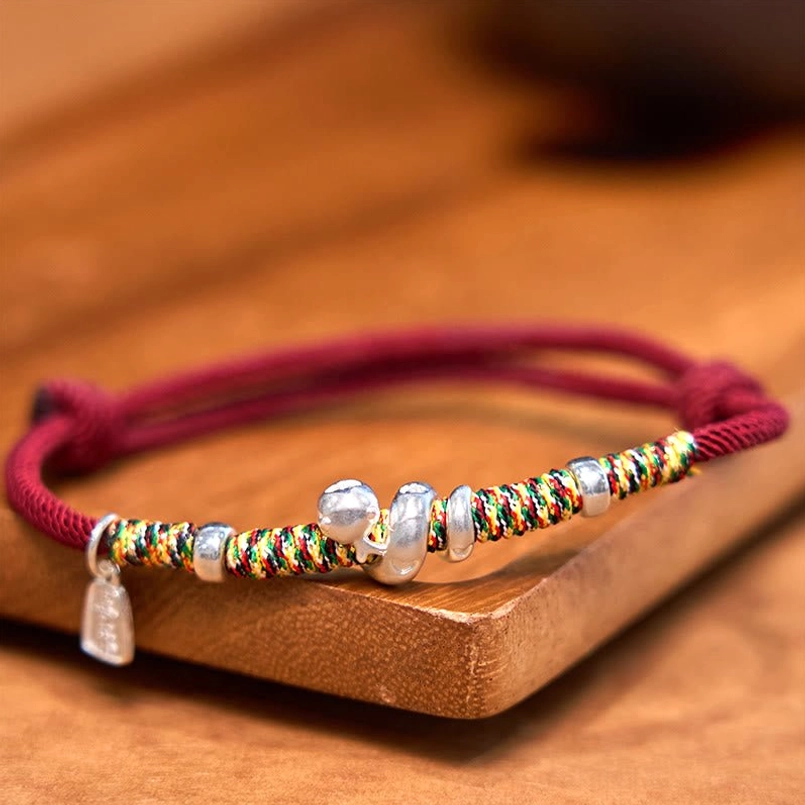 999 Sterling Silver Year of Snake Red String Bracelet on wooden display tray