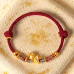Year of the Horse 999 silver gold plated red string bracelet top flat lay