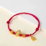Year of the Horse red string bracelet gold horse charm flat lay