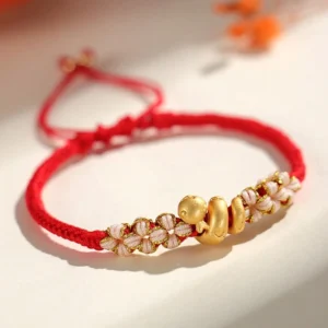 Year of the Snake red string bracelet top close up view with 999 sterling silver charm