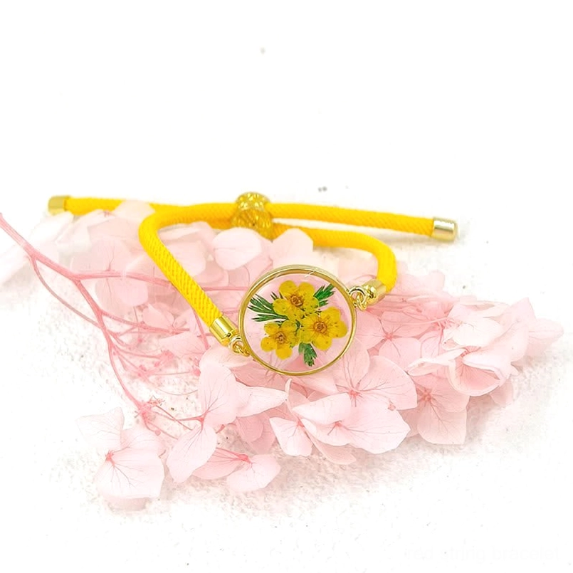 Yellow woven rope birth flower bracelet with clustered yellow flower resin charm