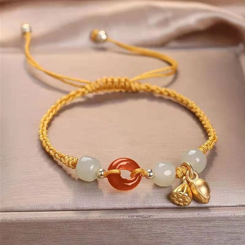 Yellow braided red string bracelet red agate peace buckle jade lotus charm on satin tray