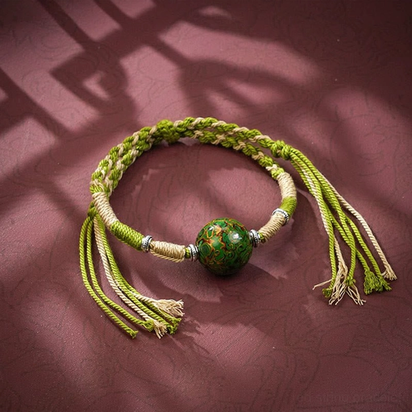 Yellow green gradient braided red string bracelet with glossy lacquer bead
