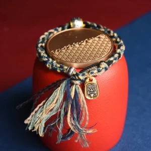 Handmade Zakiram Goddess red string bracelet with copper beads and metal charm, blue and multicolor design