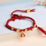 Zakiram Goddess of Wealth Tibetan red string protection bracelet flat lay view